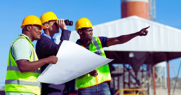 Project manager and contractors at a construction site